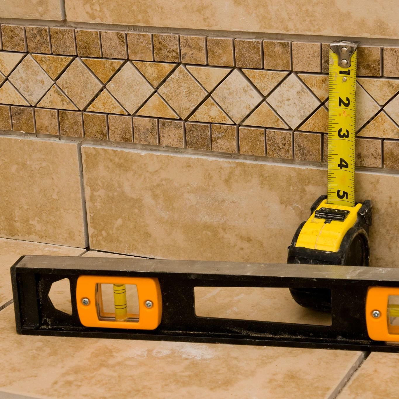 Tape measure and spirit level on tiled floor - Free in-home measurements by The Carpet Shoppe Inc in Tulare, CA