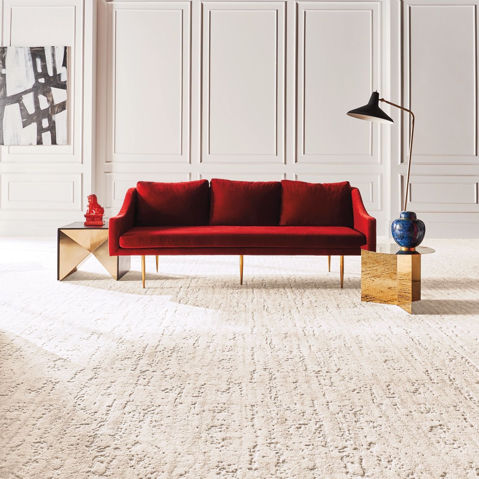 Bright living room with red velvet couch and beige textured carpet from The Carpet Shoppe Inc in Tulare, CA